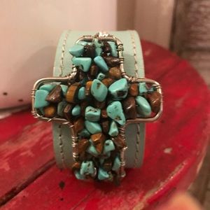 Leather turquoise cross cuff with crystals.